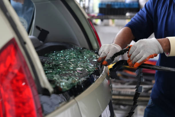 Auto glass technician replacing rear window